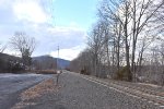 Viewed from the White House Station parking lot, we can see an example of the Raritan Valley Line west of Raritan being rural-the hills that surround the right of way